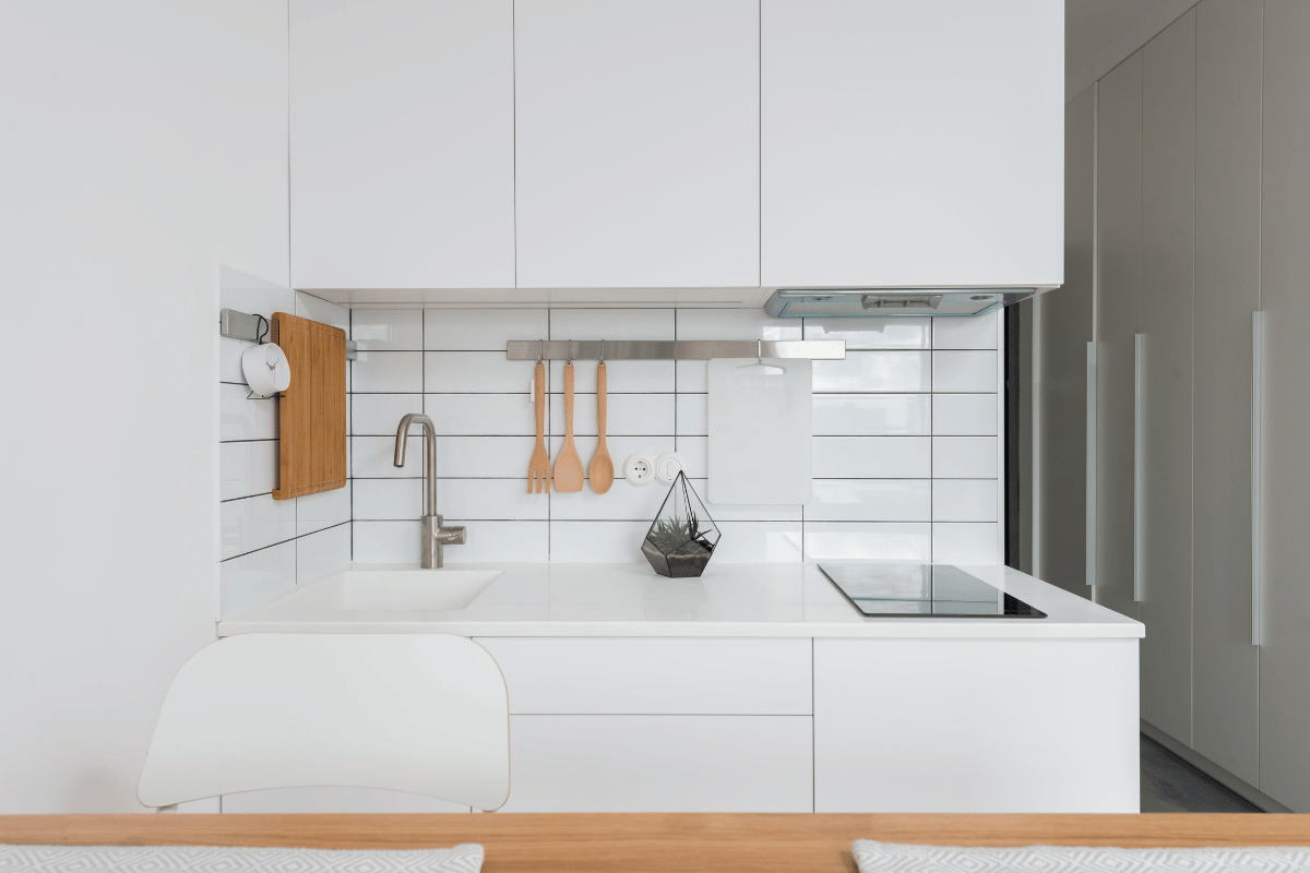 Minimalist white kitchen with white slab cabinet doors